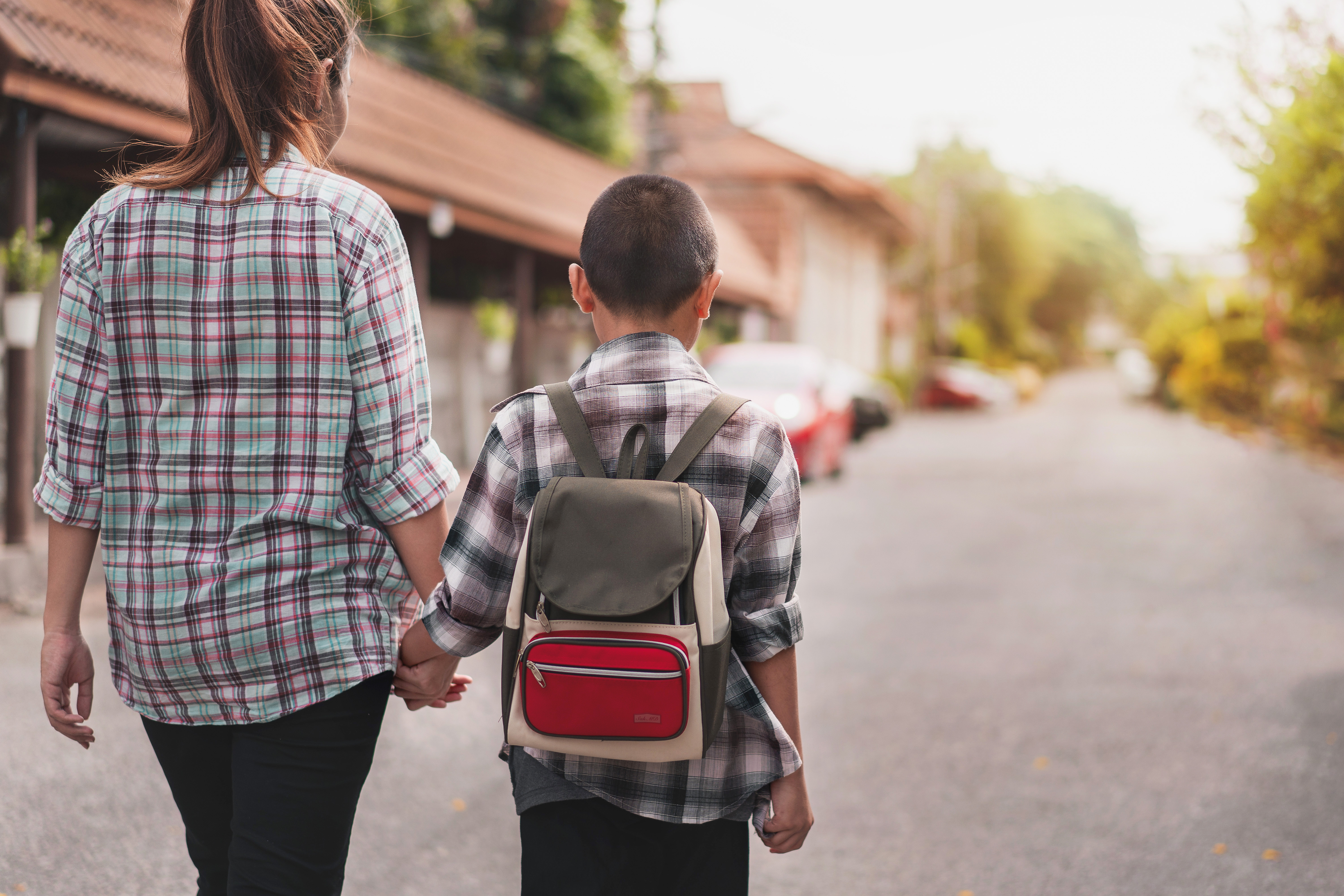 mother walking son to school
