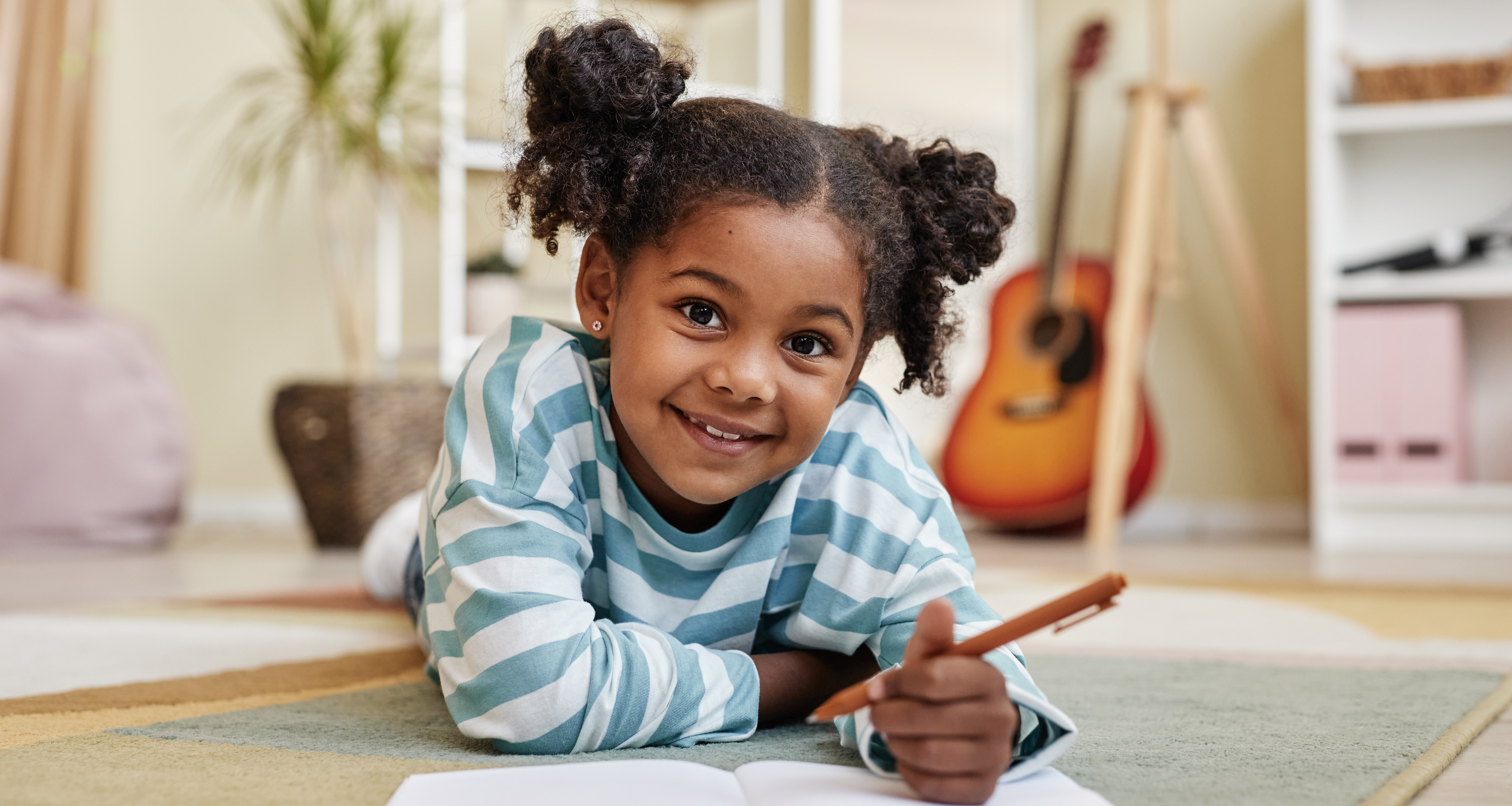 girl journaling on floor in room mental health tips and activities calendar