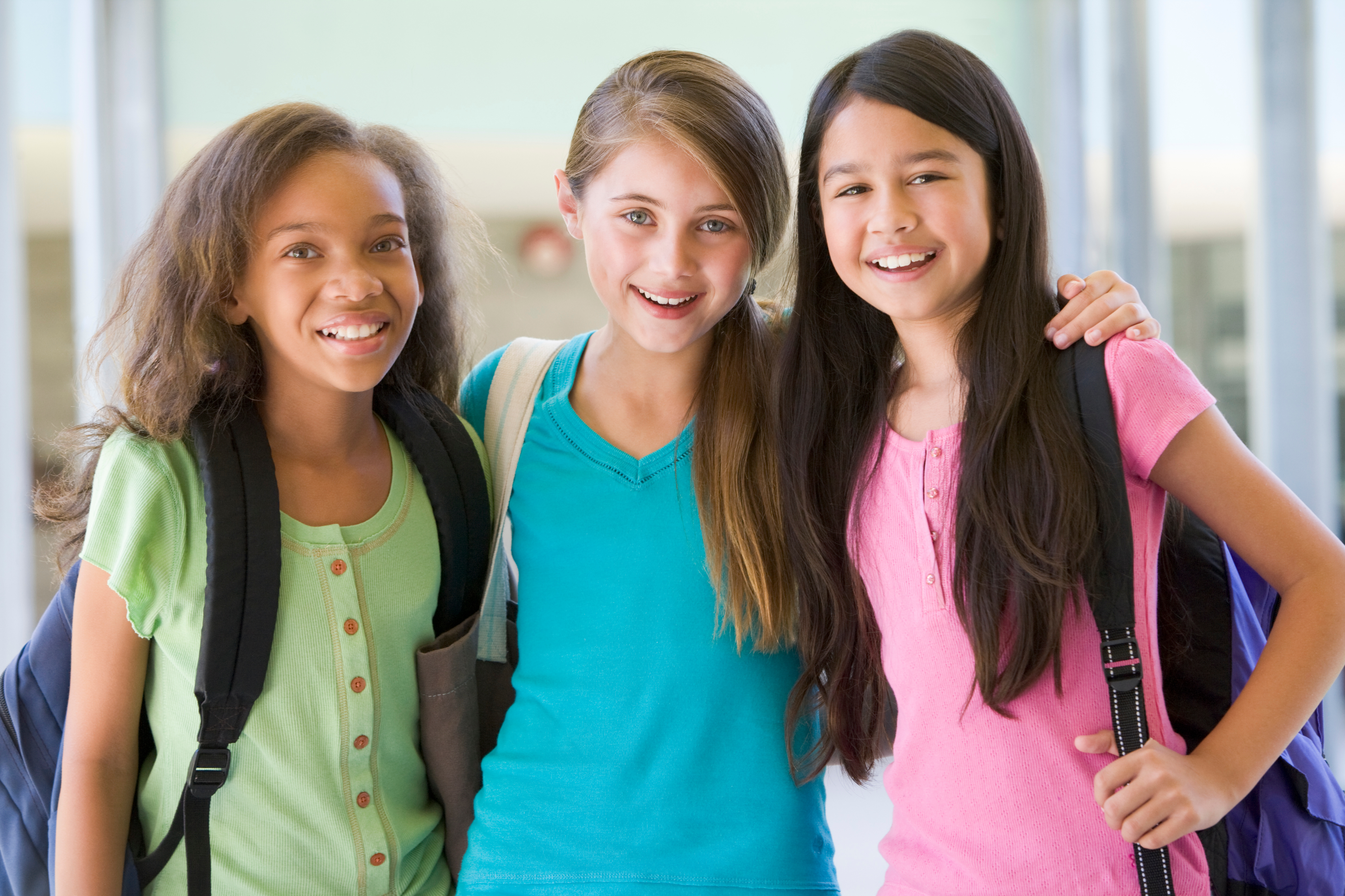 puberty in girls group of 3 elementary school girls african american white hispanic