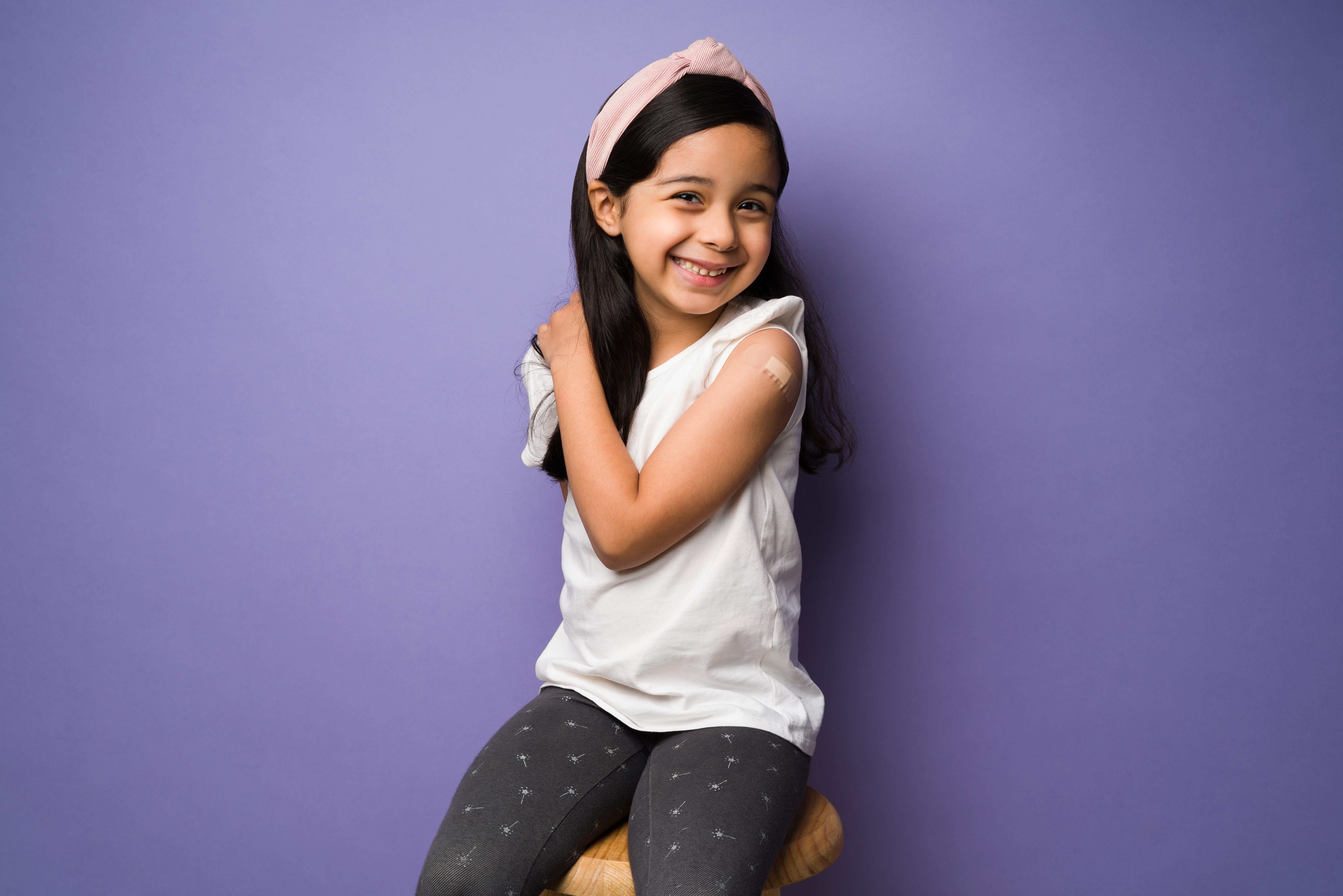 girl with bandaid after flu shot vaccine flu shot clinic annapolis pediatrics smiling kid influenza