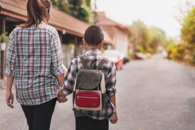 mother walking son to school
