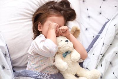 little girl with hands over face hand foot mouth disease illness fever rash blisters