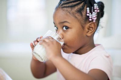girl drink milk vitamin D beverage nutrition black child African American protein alternative healthy growth